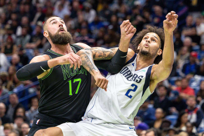 Mavs' Dereck Lively II and Pelicans' Jonas Vananciunas battle for a rebound.